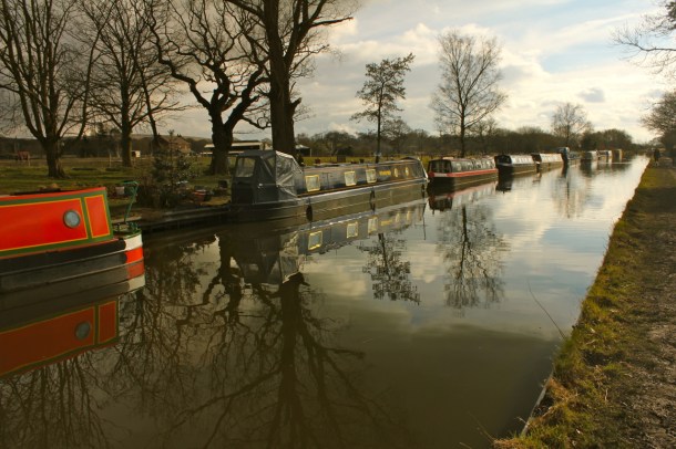 Trees reflect in the canal's water